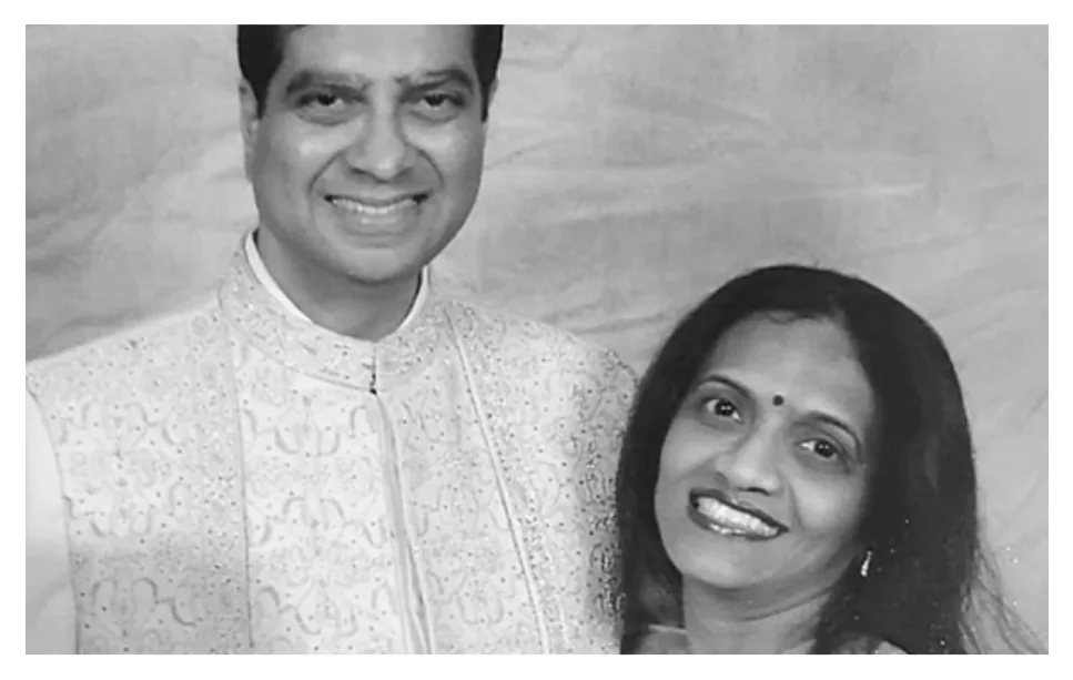 Video-2.png Black-and-white photo of a smiling couple in embroidered formal Indian dress.